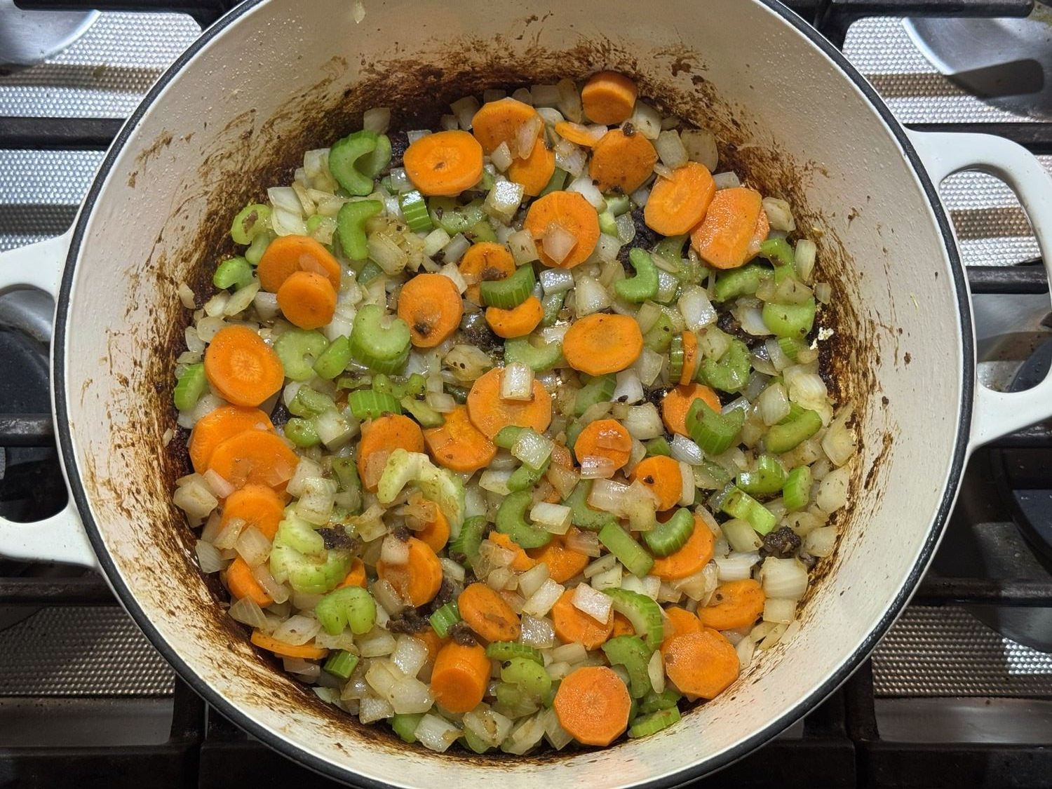Diced onion, carrots, and celery cooking in the pot