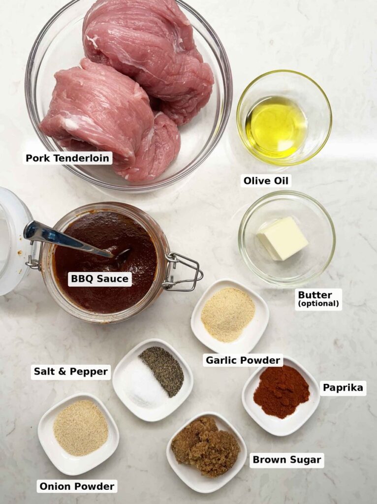 Labeled ingredients for brown sugar BBQ pork tenderloin: pork tenderloin, oil, brown sugar, garlic powder, onion powder, paprika, kosher salt, black pepper, and BBQ sauce
