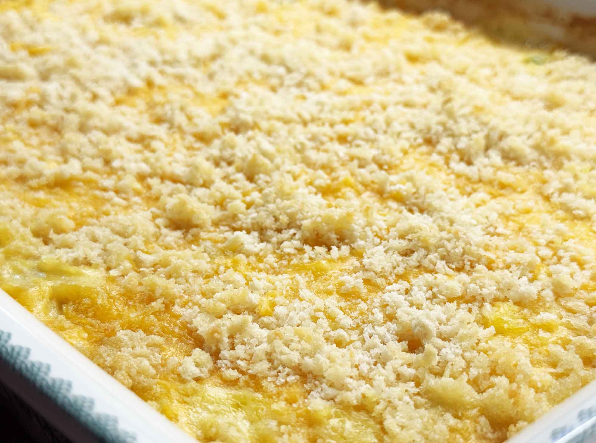 Close-up of melted cheddar and buttery panko topping on a baked chicken noodle casserole