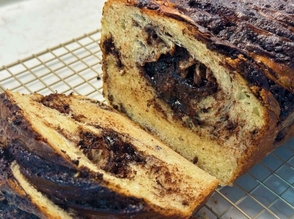 Sliced chocolate babka bread showing swirls of chocolate inside