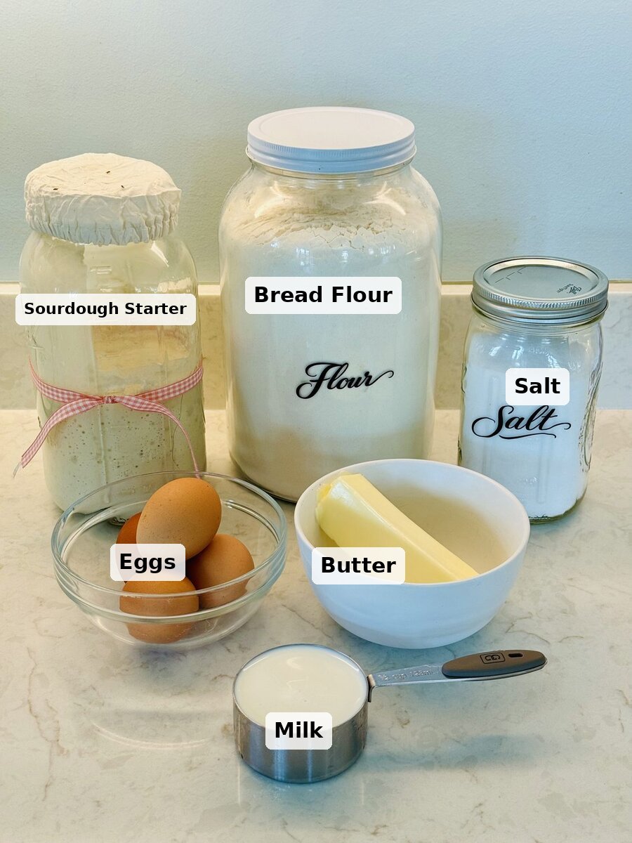 Ingredients for chocolate sourdough babka: bread flour, sourdough starter, milk, eggs, butter, sugar, and salt