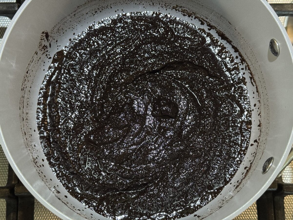 Melted chocolate babka filling in a small pot, smooth and glossy