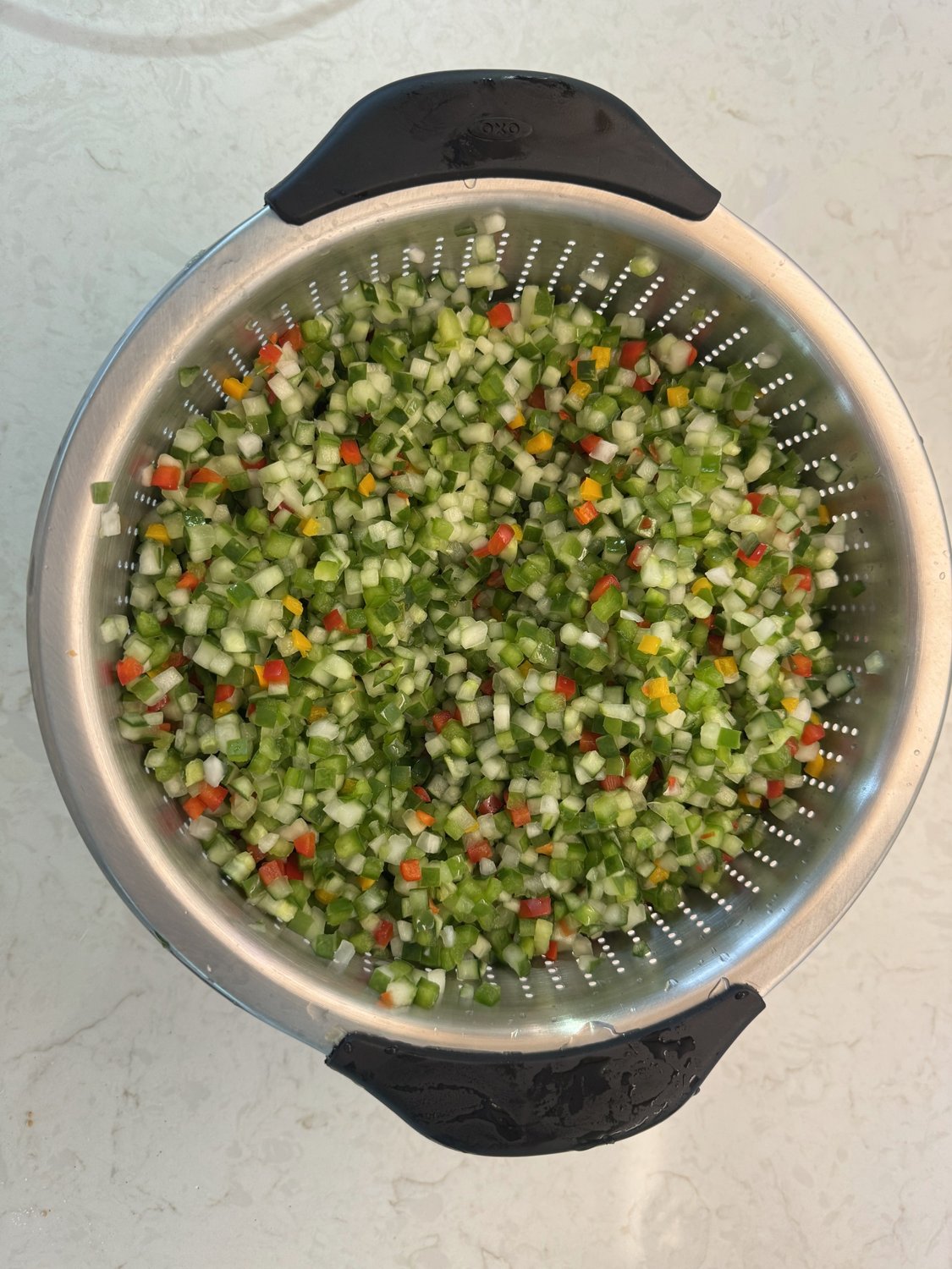 Soaked relish vegetables draining in a stainless steel colander