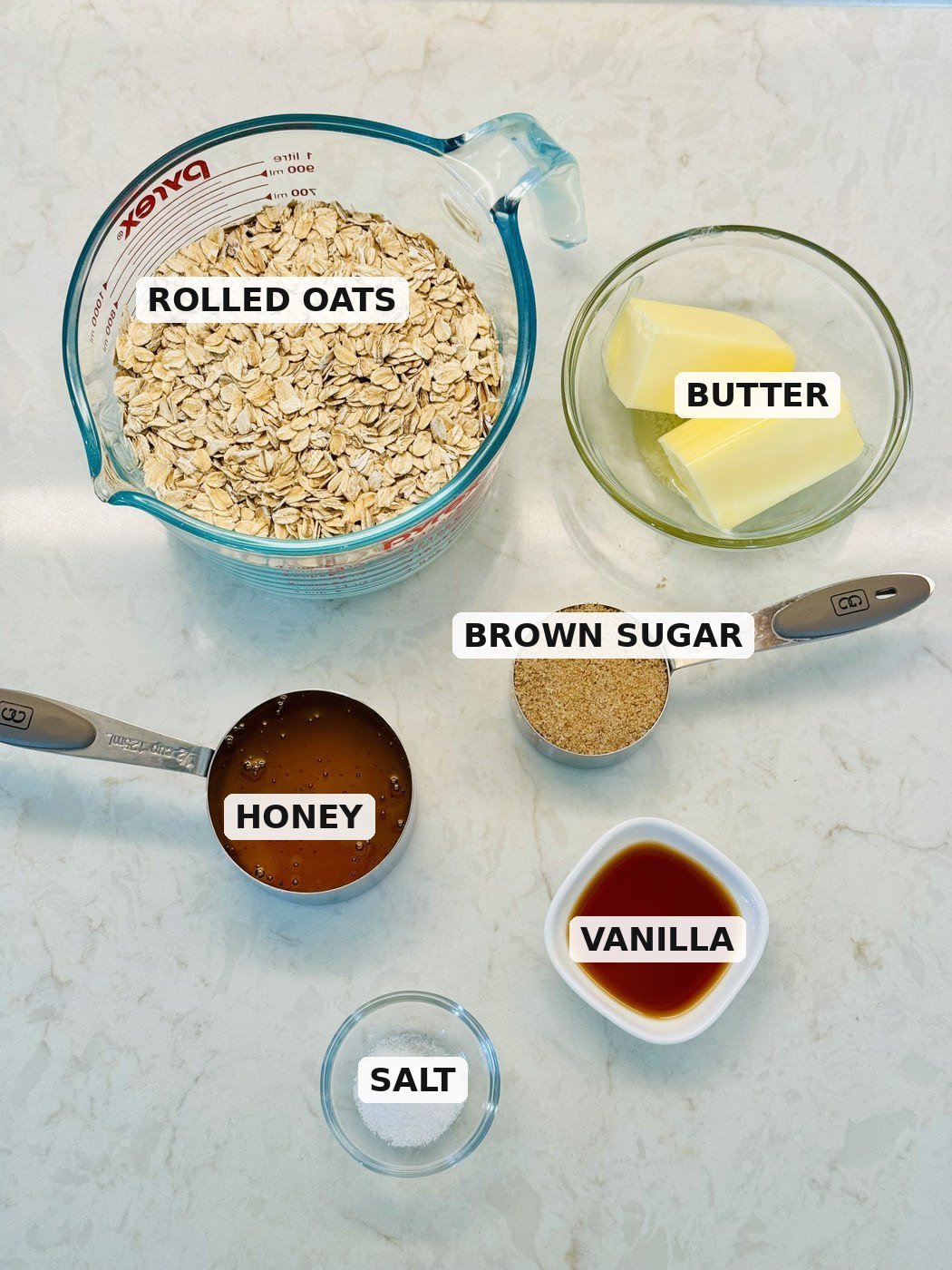 Labeled ingredients for oatmeal breakfast bars: rolled oats, butter, honey, brown sugar, vanilla, and salt.