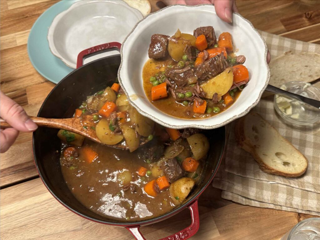 Serving beef stew at the dinner table