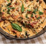 Marry Me Chicken made in a cast iron skillet with seared chicken breasts, sun-dried tomatoes, cream, Parmesan, and fresh garden herbs, all in one skillet in about 30 minutes.