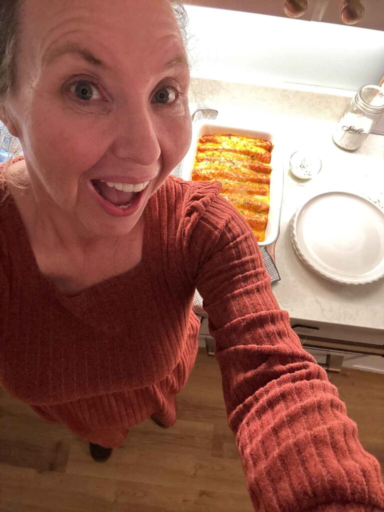 Jennifer poses with her fresh chicken enchiladas, warm from the oven