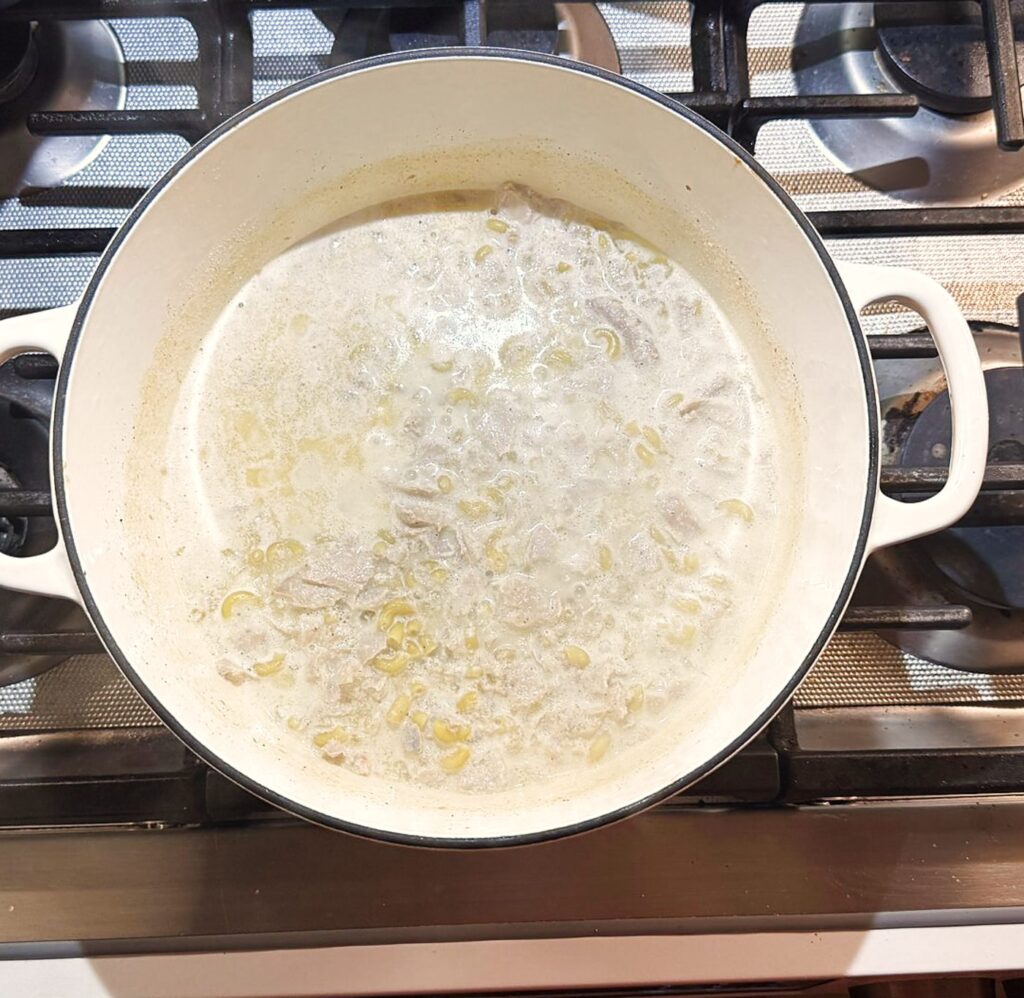 Creamy tuna pasta simmering on a stove