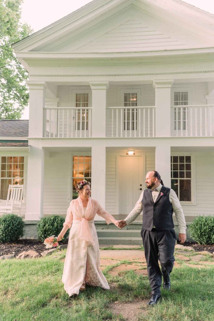 Jennifer and Greg walking out of the farmhouse after marrying
