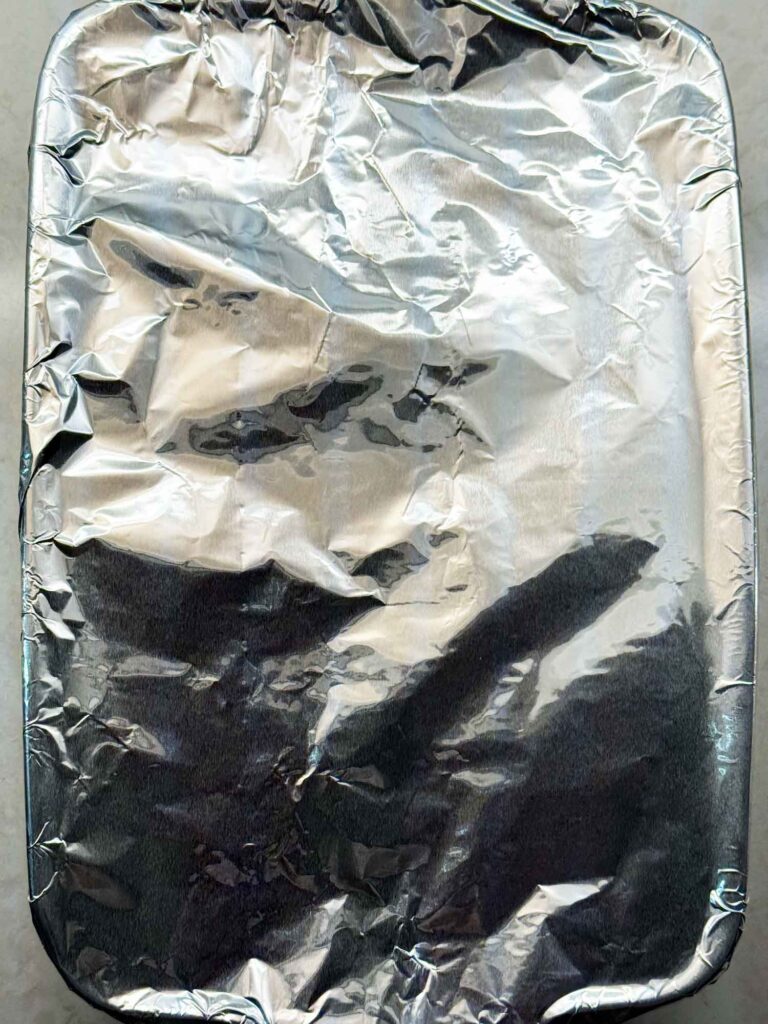 A baking pan covered with aluminum foil