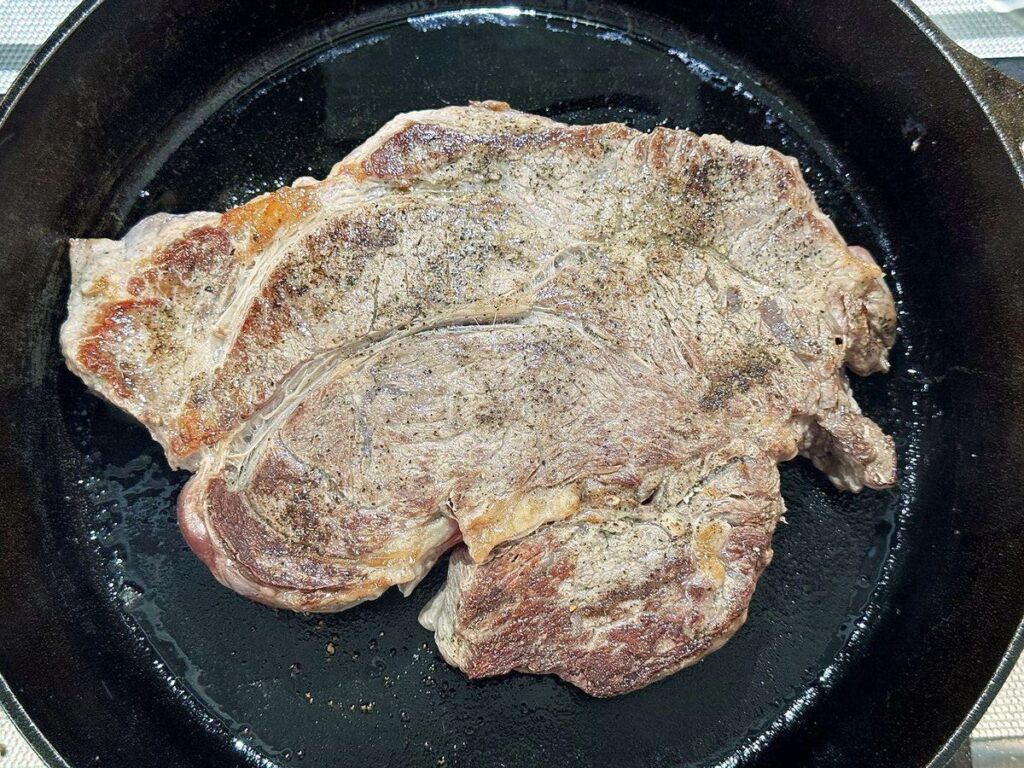 Searing the chuck roast in a skillet