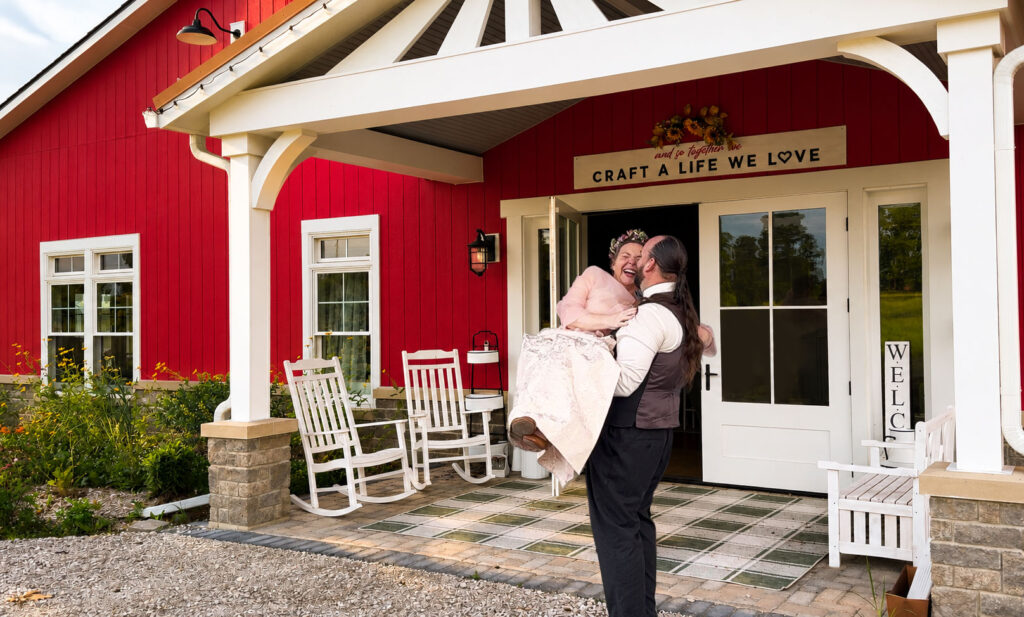 Greg carrying Jennifer over the threshold