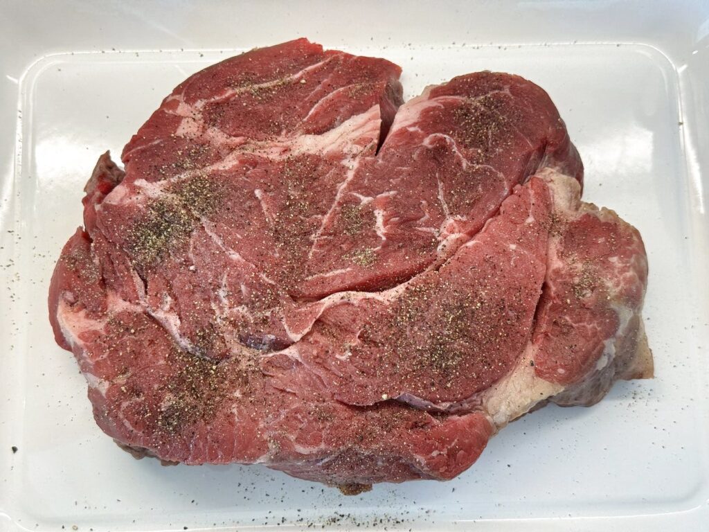 Boneless chuck blade roast patted dry and seasoned with kosher salt and black pepper