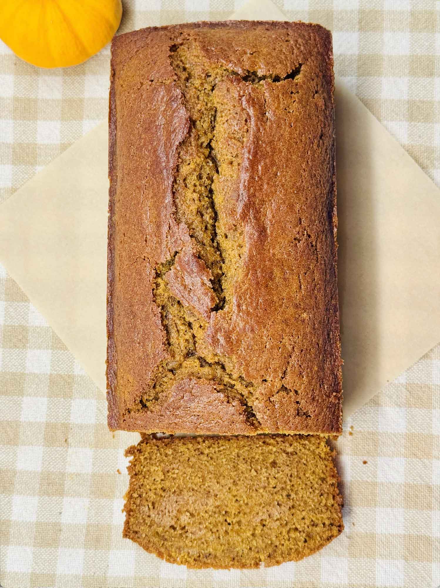 Close up of the tender golden crumb of a sliced pumpkin bread loaf