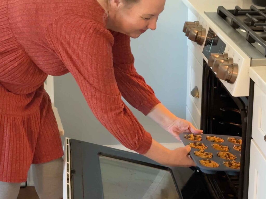 Putting the muffin tin into the oven