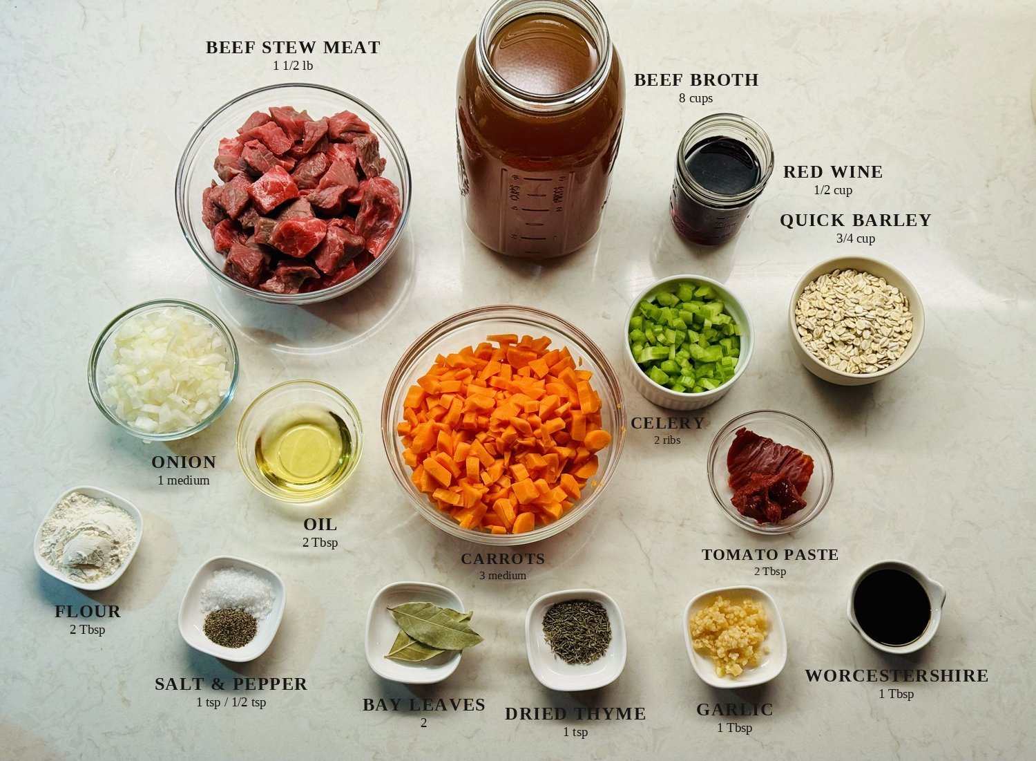 Labeled ingredients for beef barley soup: beef stew meat, beef broth, red wine, quick barley, onion, oil, carrots, celery, tomato paste, flour, salt and pepper, bay leaves, dried thyme, garlic, and Worcestershire sauce