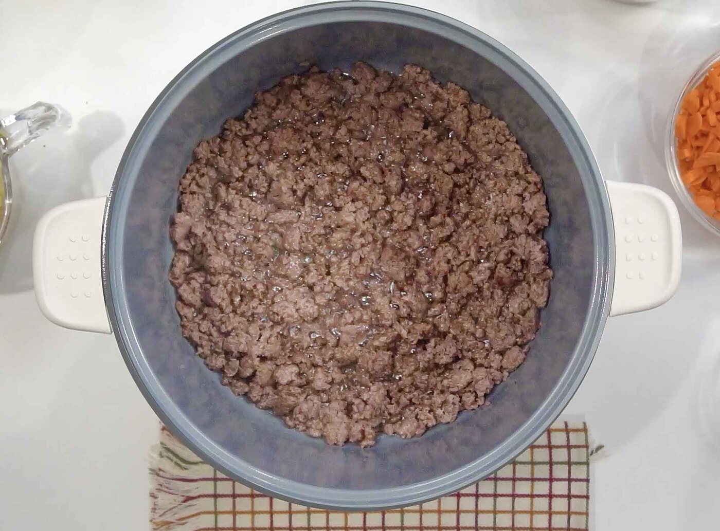 Overhead view of browned ground beef crumbles in a large pot