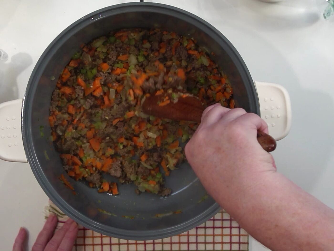 Flour stirred into ground beef and vegetables until everything is coated