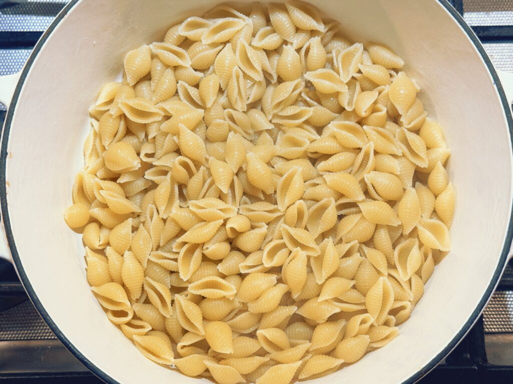 Pot of cooked pasta shells with butter