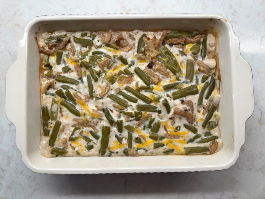 Overhead view of green bean casserole after 25 minutes in the oven, before the onion topping