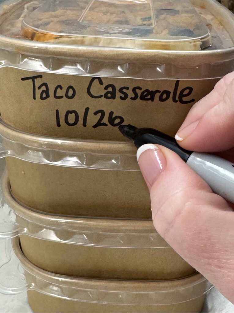 Labelling a paper leftover container with a black marker