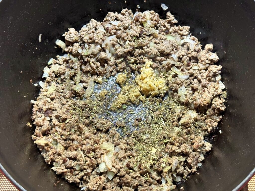 Jarred garlic, Italian seasoning, and pepper added to the beef and onion