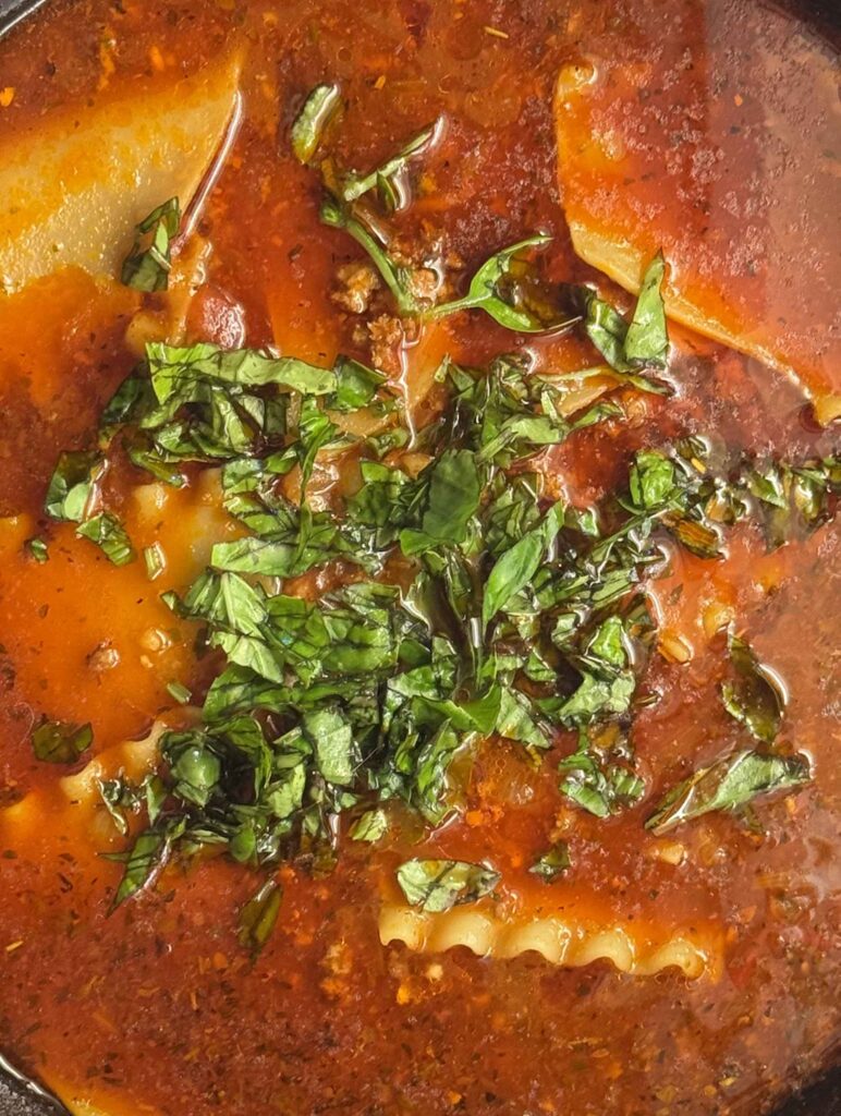 Closeup of finished lasagna soup with fresh basil