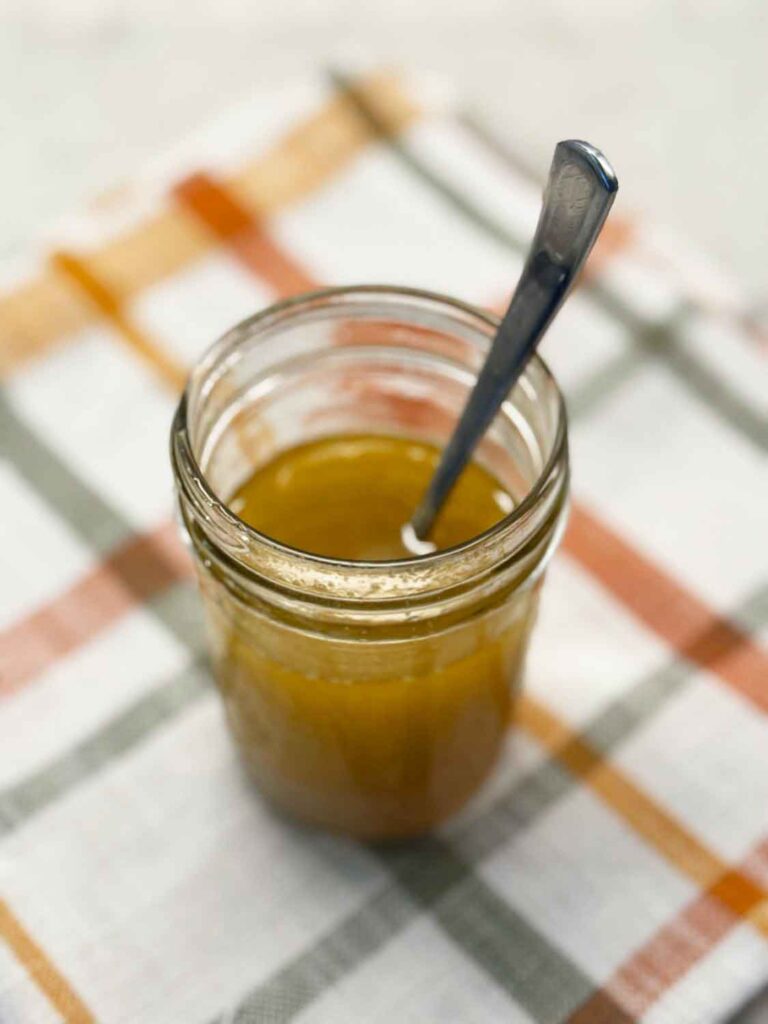 Maple vinaigrette in a mason jar with a spoon