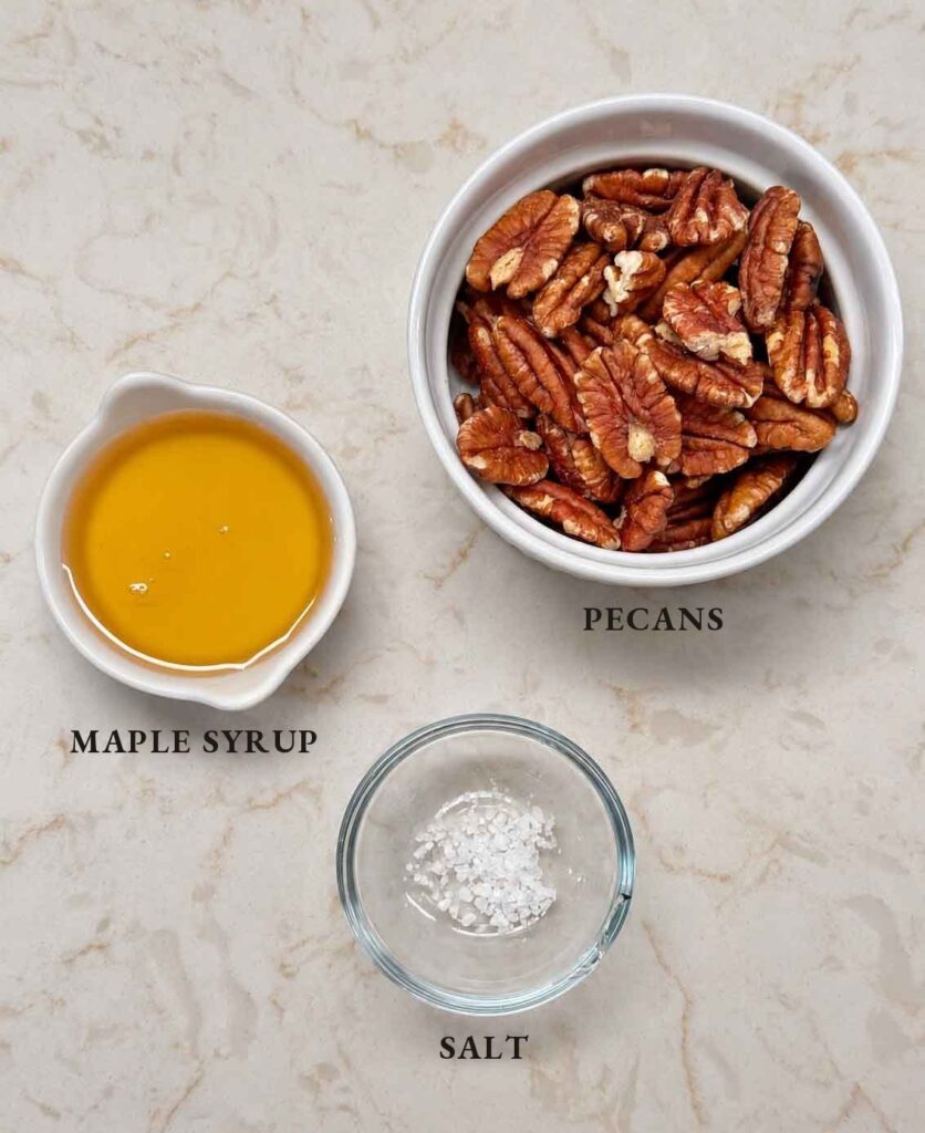 Labeled ingredients for maple pecans: pecan halves, maple syrup, and salt