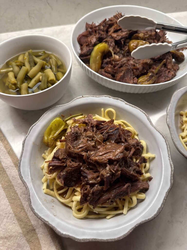 ProofMode photo of our pot roast dinner on the counter with meat, noodles, and green beans