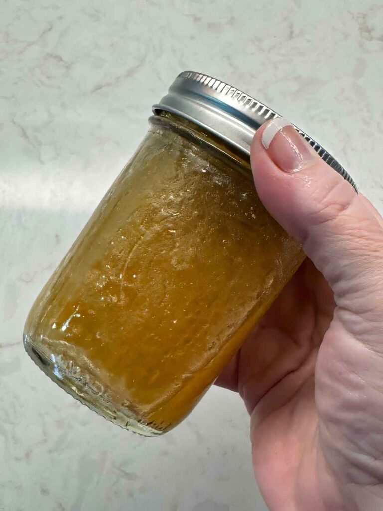Shaking a mason jar of maple vinaigrette 