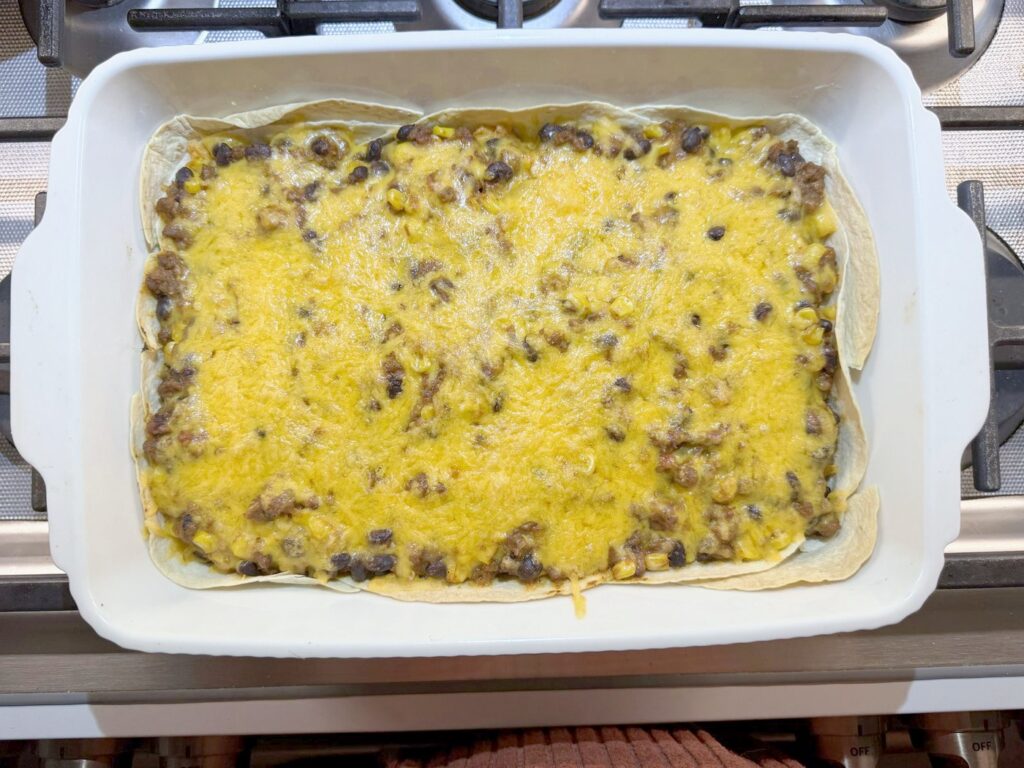 Overhead view of taco casserole after 20 minutes in the oven, with melted bubbling cheese