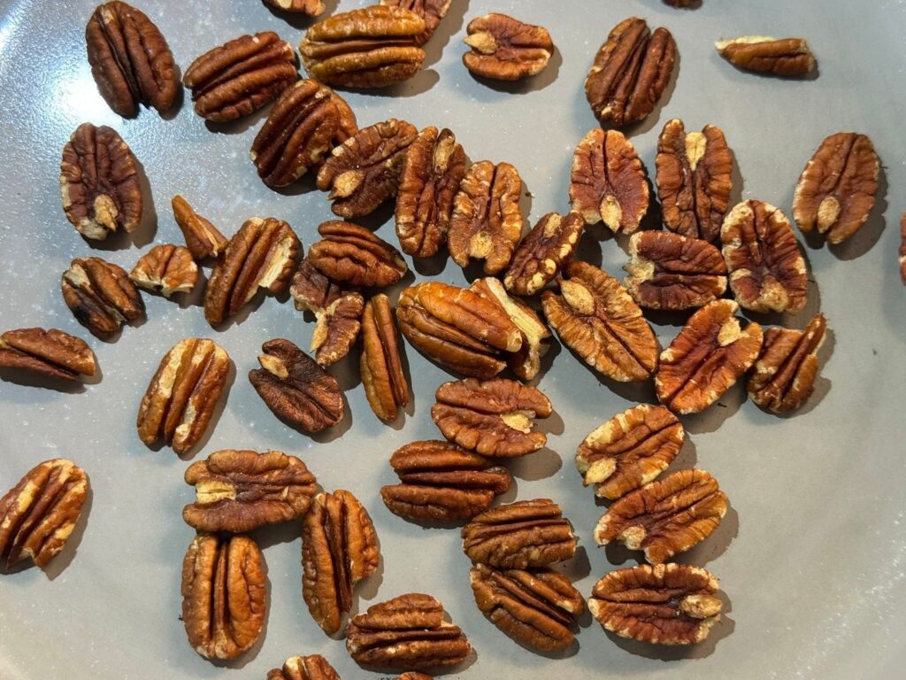 Pecan halves toasting in a dry skillet