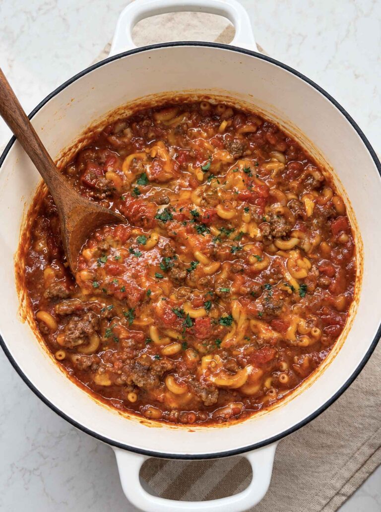 Big pot of venison goulash with a spoon in it